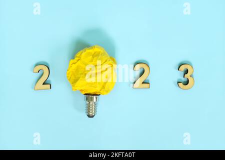 New year 2023 innovation, creativity in business ideas concept. 2023 text with bright yellow light bulb. Stock Photo