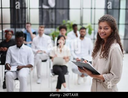 Selective focus of lecturer talking to audience during seminar in conference room Stock Photo