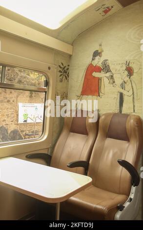 Interior of the tourist car of the train from Cusco to Machu Picchu standing at the station in Ollantaytambo Stock Photo