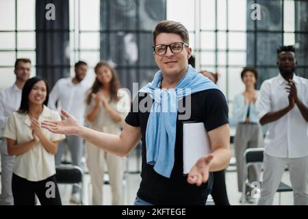 Happy diverse professional business team stand in office looking at camera Stock Photo