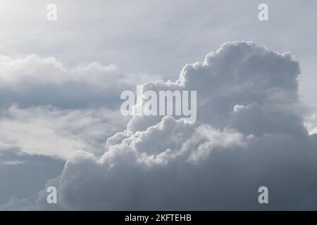 Horizontal photo. White curly clouds on a gentle blue sky. Stock Photo