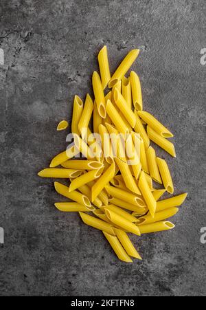 Raw Dry Penne Ziti Rigate Pasta Isolated. Top View. Stock Photo