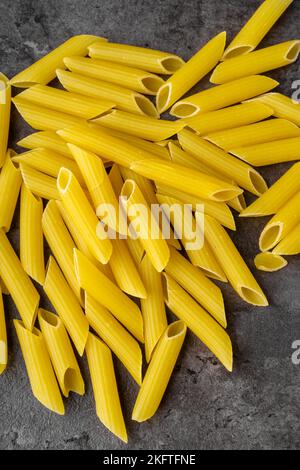 Raw Dry Penne Ziti Rigate Pasta Isolated. Top View. Stock Photo