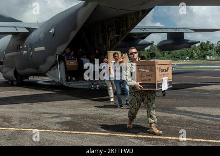 Members of the Batanes Provincial Disaster Risk Reduction Management Office (PDRRMO) and U.S. Navy unloads Humanitarian Assistance/Disaster Response (HA/DR) equipment at Basco Airport, Batanes, Philippines, Oct. 6, 2022. These events enhance HA/DR efforts in the Indo-Pacific by supporting friend, ally, and partner requests for assistance in providing military-to-civil engagements with realistic training scenarios. Stock Photo