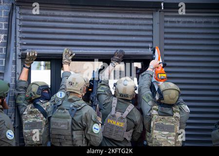 A Special Response Team (SRT) from Homeland Security Investigations (HSI) cuts  open a security door while serving a warrant as part of Operation Boiling Point on October 6, 2022 in Chicago, Illinois. Stock Photo