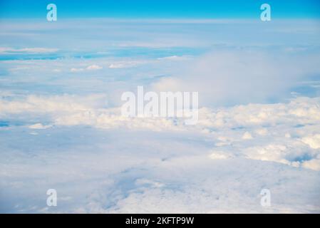 View from Boeing 737 MAX 8 on White Air Clouds, Clear Blue Sky. Stock Photo