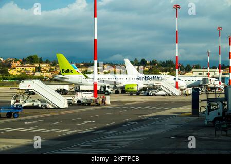 Kerkyra, Greece - 09 29 2022: View of Corfu Airport On Green Plane of AirBaltic. Parking Lot For Aircraft, Plane Is Refueled Before Takeoff, Against Stock Photo