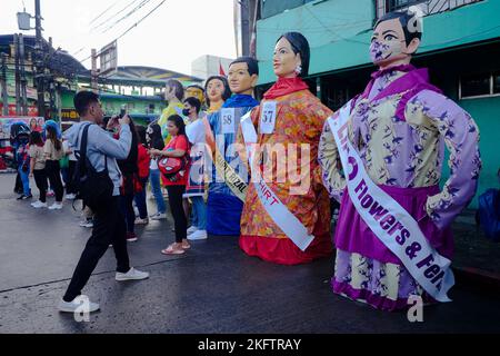 Angono, Rizal, Philippines. 20th Nov, 2022. The parade of the giant puppets in the art capital of the Philippines is back after two years of pandemic. The Higantes (giant) Festival parades the streets of Angono, Rizal province. The paper mache head puppets were originally done to put to shame corrupt officials during the Spanish rulership. Now, the Higantes came a long way and evolve into a festival on modern times from the Spanish era. The festival brings joy and entertainment to the town people of Angono and to tourists. Now, they wear a sash to represent someone or promote something with Stock Photo