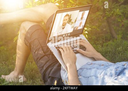 Watching Online Video Conference Meeting In Office Stock Photo