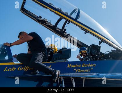 OAKLAND, California (Oct. 07, 2022) Aviation Electrician's Mate Dale Pascua, assigned to the Navy Flight Demonstration Squadron, the Blue Angels, prepares the cockpit of an F/A-18 Super Hornet prior to Monica Barbaro, Top Gun: Maverick actress, flight with Blue Angels' advance pilot and narrator, Lt. Cmdr. Griffen Stangel. The Blue Angels perform flight demonstrations at 32 locations across the country to showcase the teamwork and professionalism of the U.S. Navy and Marine Corps to the American public. Stock Photo