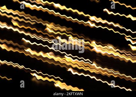 Yellow glowing swirl wave, fire light effect, line, lightning electric discharge. Twisted yellow glowing wavy curves. Technology, data flow on black i Stock Photo