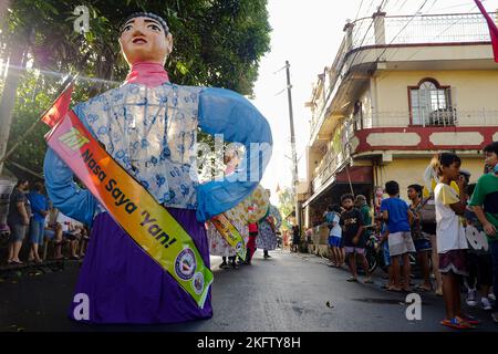 Angono, Rizal, Philippines. 20th Nov, 2022. The parade of the giant puppets in the art capital of the Philippines is back after two years of pandemic. The Higantes (giant) Festival parades the streets of Angono, Rizal province. The paper mache head puppets were originally done to put to shame corrupt officials during the Spanish rulership. Now, the Higantes came a long way and evolve into a festival on modern times from the Spanish era. The festival brings joy and entertainment to the town people of Angono and to tourists. Now, they wear a sash to represent someone or promote something with Stock Photo