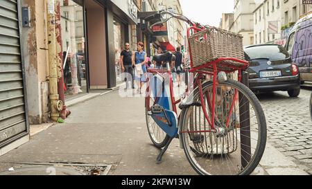 PARIS, FRANCE - AUGUST 09, 2015: the bicycle is parked in the street in Paris. Stock Photo