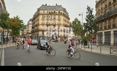 PARIS, FRANCE - AUGUST 09, 2015: group of people ride bikes in Paris in the daytime Stock Photo