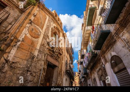 Aged buildings in the historic center of Palermo with clothes hanging on the balconies Stock Photo