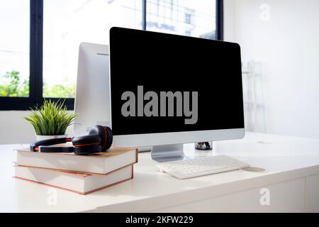 Desktop computer mockup on desk at home office, mock up display screen blank for template minimal style, nobody. Stock Photo