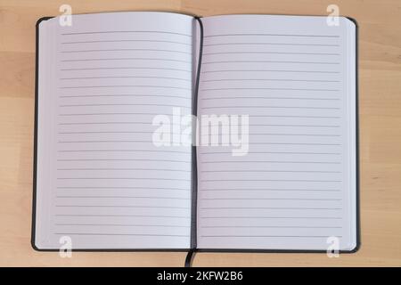Empty lined notebook on wooden table. Ruled paper notebook Stock Photo