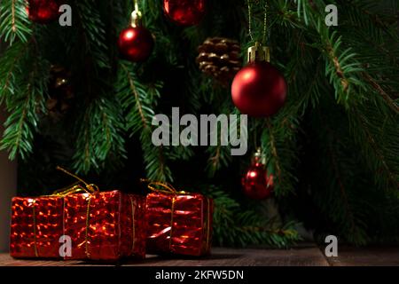 Red Christmas gifts on the background of the Christmas tree, Christmas composition Stock Photo