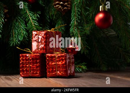 Red Christmas gifts on the background of the Christmas tree, Christmas composition Stock Photo