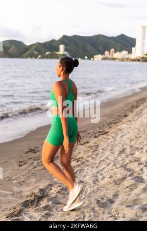Young woman doing some warm-up exercises before running. Stock Photo