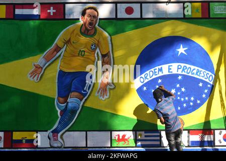 Kolkata, West Bengal, India. 20th Nov, 2022. A painter applies finishing touches to an image of Brazil's national flag with Neymar da Silva Santos JÃºnior, on a wall along a road ahead of the FIFA World Cup, in Kolkata. (Credit Image: © Sudipta Das/Pacific Press via ZUMA Press Wire) Stock Photo