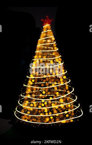 Blurred yellow Christmas tree lights with particles and circles on black isolated background. Design element. Defocused spruce with star. Overlay. New Stock Photo