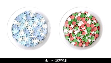 Snowflake and star shaped confetti sprinkles, in white bowls. Confetti candy, confectionery product, made of sugar and rice. Stock Photo