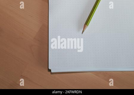 Paper with pencil on wooden table. Pencil on table, the blogger instrument Stock Photo