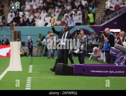 Al Khor, Qatar. Al Bayt Stadium, Al Khor, Qatar; 20th November 2022; FIFA World Cup Football, Opening Ceremony; France 98 World Cup Winner Marcel Desailly holds up the FIFA World Cup Trophy for the fans Credit: Action Plus Sports Images/Alamy Live News Stock Photo
