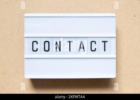 Lightbox with word contact on wood background Stock Photo