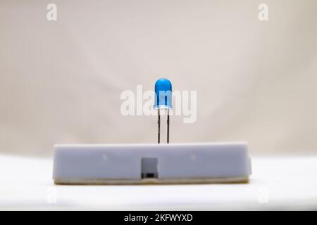 Selective focus from a blue LED embedded in the project board. This part is used by electronics hobbyists for DIY materials. Stock Photo