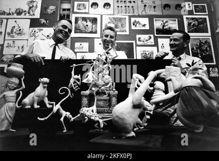 Director WOLFGANG REITHERMAN (left) and Directing Animator JOHN LOUNSBURY (right) candid posing with Animation models during production of THE JUNGLE BOOK 1967 director WOLFGANG REITHERMAN inspired by the Mowgli Stories by Rudyard Kipling producer / presenter WALT DISNEY Walt Disney Productions Stock Photo