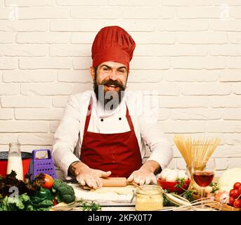 Chef makes dough. Italian cuisine concept. Man with beard Stock Photo