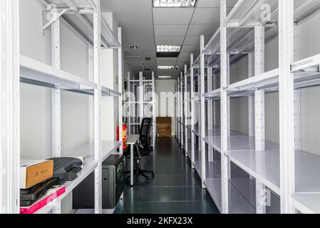 Empty storage room in coworking space. Startup business office interior at new workplace. Empty shelves Stock Photo