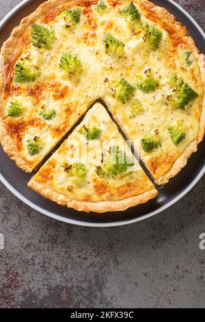 Open pie with fresh romanesco broccoli, eggs and cheese close-up in a plate on the table. Vertical top view from above Stock Photo