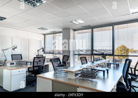 Empty places for workers in contemporary coworking. Startup business office interior at new workplace. Open space office interior Stock Photo