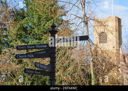 Signpost and the 15th century church tower of St Mary, Walthamstow Village, North East London, UK Stock Photo