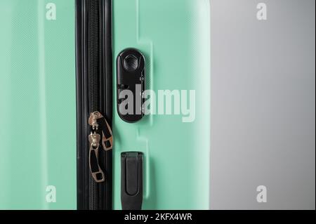 Close-up of a combination lock of a mint plastic suitcase.  Stock Photo