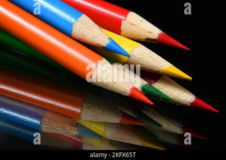 Colored Pencil Points on dark glass Stock Photo