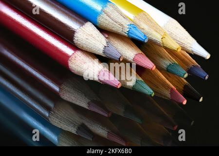 Colored Pencil Points on dark glass Stock Photo