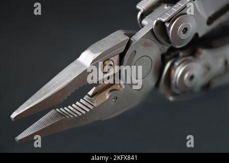 Multitool close up on dark glass Stock Photo