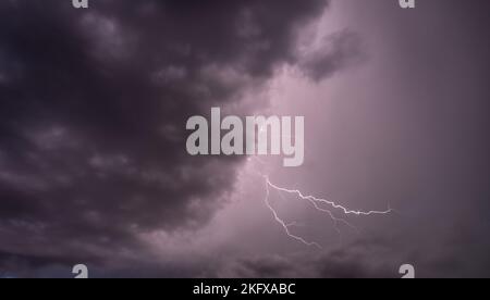 Lightning through cloudy sky Stock Photo - Alamy