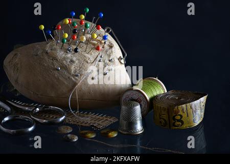 Vintage Sewing Pincushion with Needle, Thread, and Thimble. Stock Photo