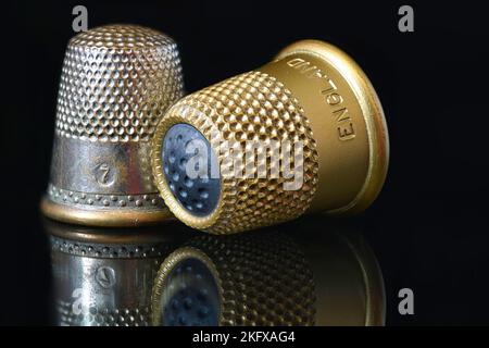 Close up of Vintage Thimbles on dark glass Stock Photo
