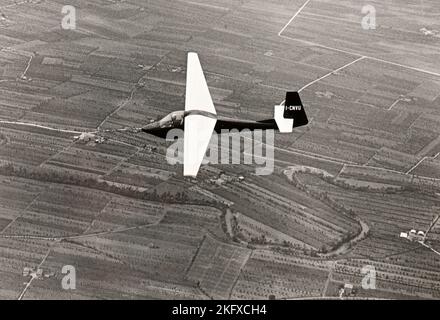 A glider soars over the countryside of Piedmont (Italy) in mid fifties Stock Photo