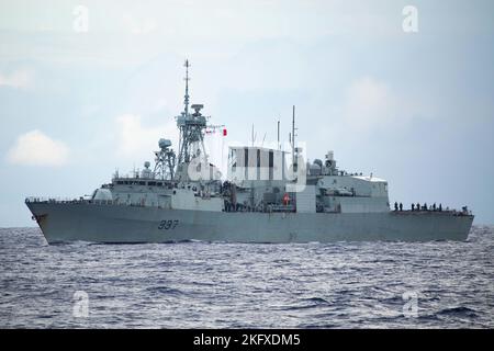 221013-N-LK647-1050 ATLANTIC OCEAN—A view from the Ticonderoga-class guided-missile cruiser USS Normandy (CG 60) of Canadian Halifax-class frigate HMCS Fredericton (FFH-337) participating in a screen formation while Normandy is underway as part of the Gerald R. Ford Carrier Strike Group, Oct. 13, 2022. The first-in-class aircraft carrier USS Gerald R. Ford (CVN 78) is on its inaugural deployment conducting training and operations alongside NATO Allies and partners to enhance integration for future operations and demonstrate the U.S. Navy’s commitment to a peaceful, stable and conflict-free Atl Stock Photo