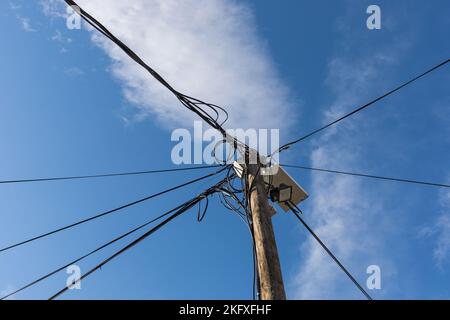 Wooden pole with electric cables Stock Photo