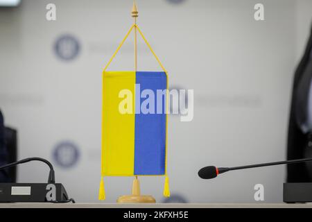 Shallow depth of field (selective focus) details with an Ukrainian flag during a press conference. Stock Photo
