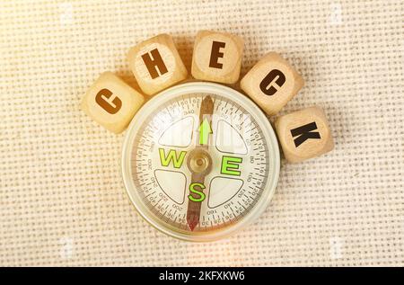 Business concept. On the table is a compass and cubes with the inscription - CHECK Stock Photo