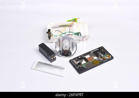 Electronics garbage for recycle on white background,battery,flashlight and mobile phone Stock Photo